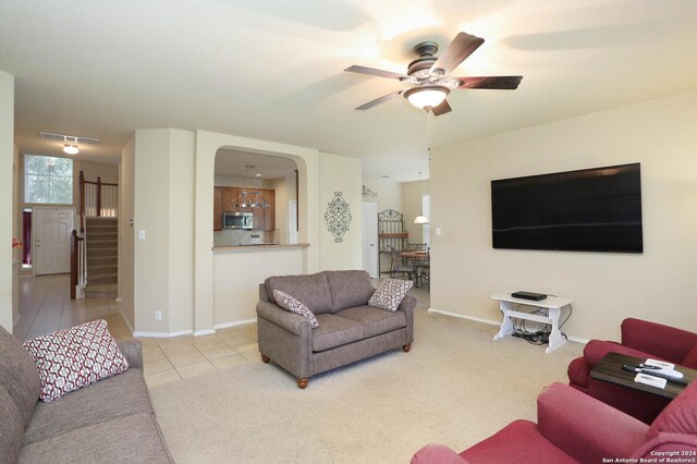 tiled living room featuring ceiling fan