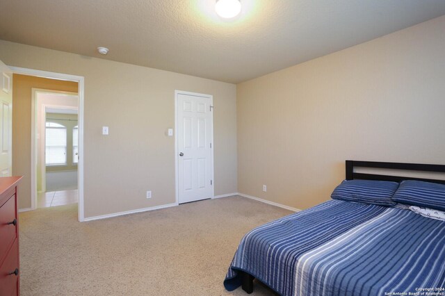 carpeted bedroom featuring a textured ceiling