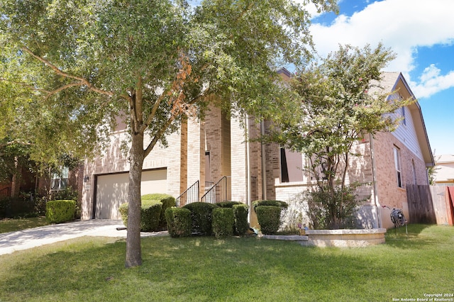 view of front of house with a garage and a front lawn