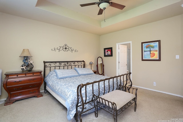 bedroom featuring carpet, ceiling fan, and a tray ceiling