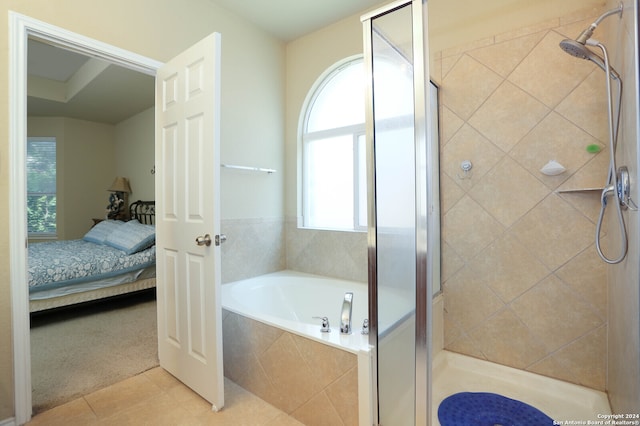 bathroom featuring tile patterned flooring and separate shower and tub