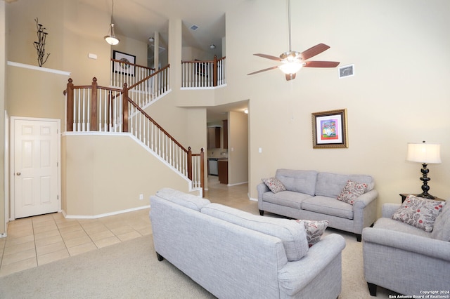 tiled living room with high vaulted ceiling and ceiling fan