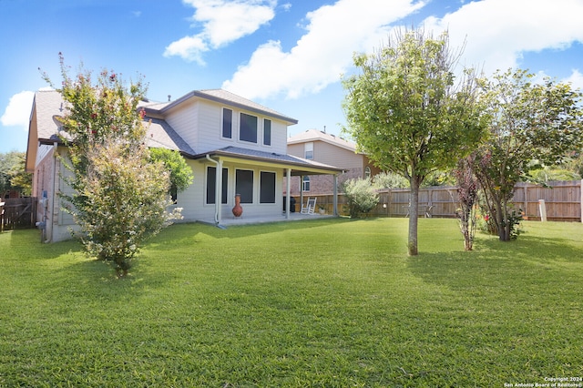 back of property featuring a lawn