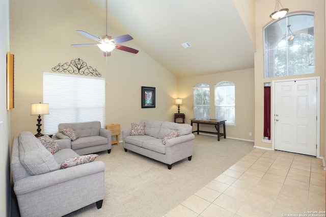 living room with high vaulted ceiling, light colored carpet, and ceiling fan