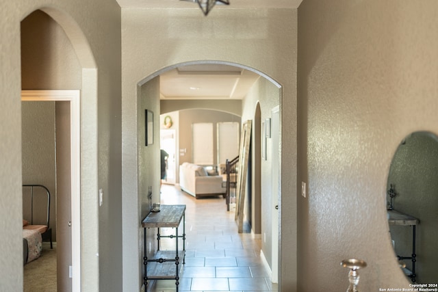 corridor with light tile patterned flooring