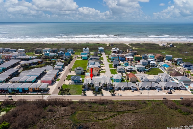 birds eye view of property featuring a water view and a view of the beach