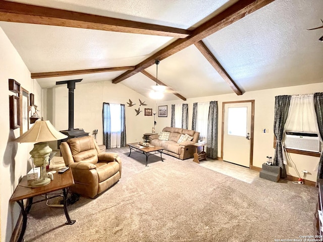 carpeted living room with a textured ceiling, ceiling fan, a wood stove, and lofted ceiling with beams