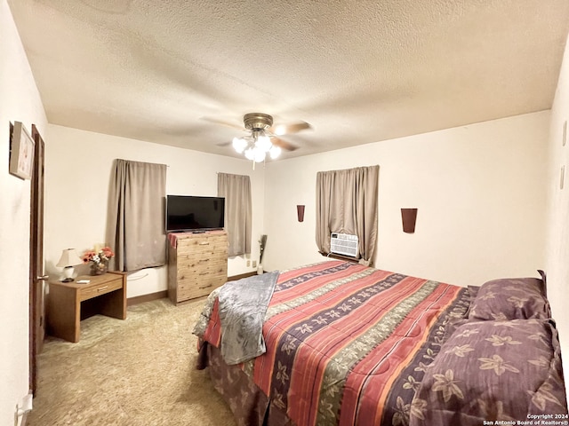 bedroom featuring light carpet, ceiling fan, and a textured ceiling