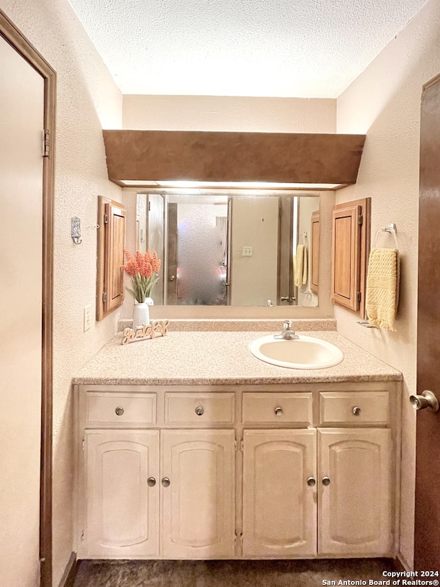 bathroom featuring vanity and a textured ceiling