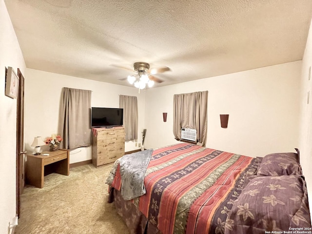 bedroom with a textured ceiling, light carpet, cooling unit, and ceiling fan