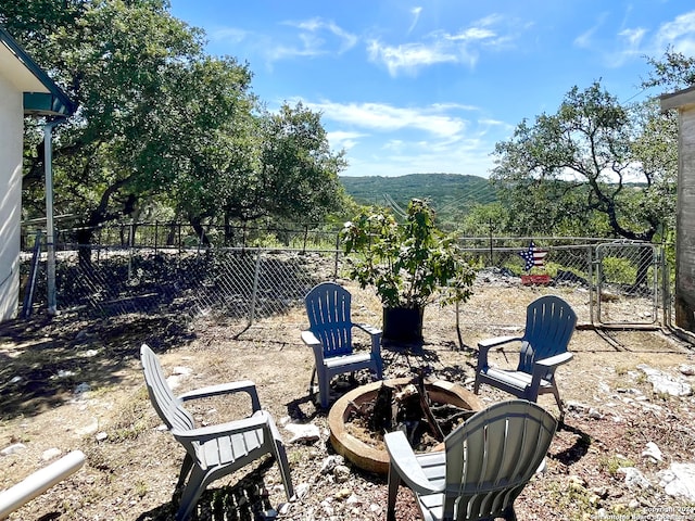 view of patio / terrace with a fire pit and a mountain view