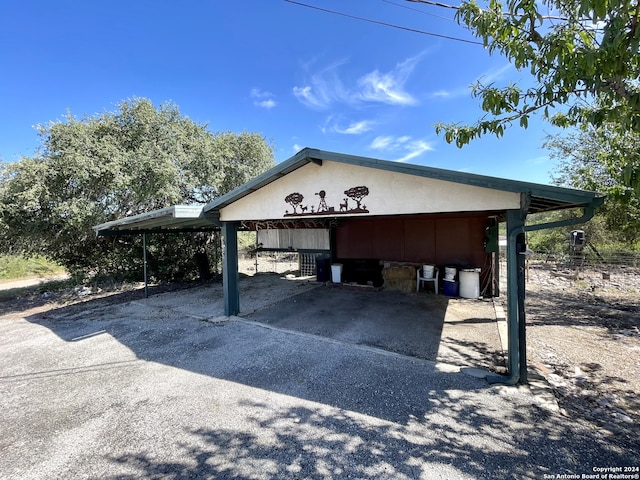 view of vehicle parking with a carport