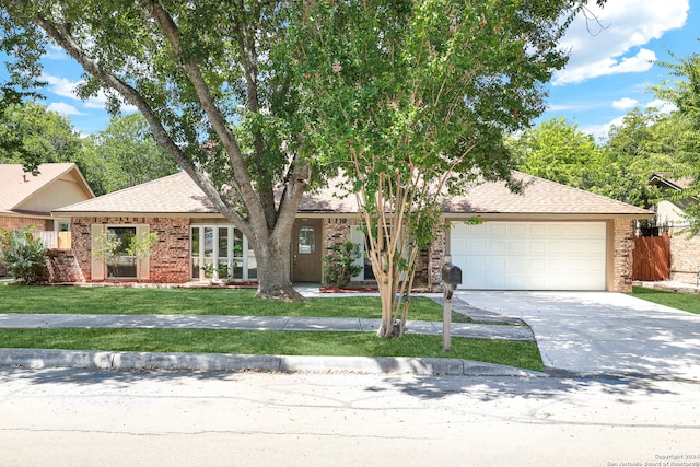 ranch-style house with a garage and a front yard