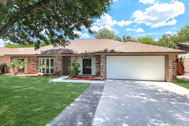 ranch-style home featuring a front yard and a garage