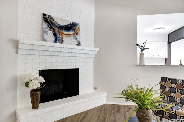 room details with hardwood / wood-style flooring and a brick fireplace