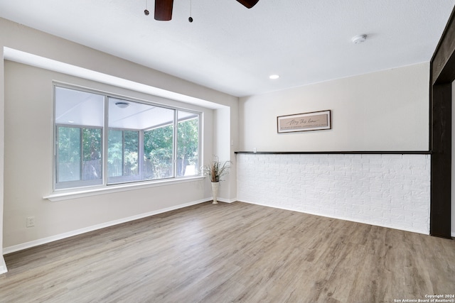 unfurnished room with ceiling fan and hardwood / wood-style flooring