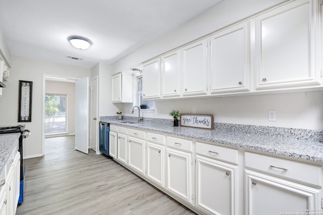 kitchen featuring sink, light hardwood / wood-style flooring, white cabinets, and stainless steel dishwasher