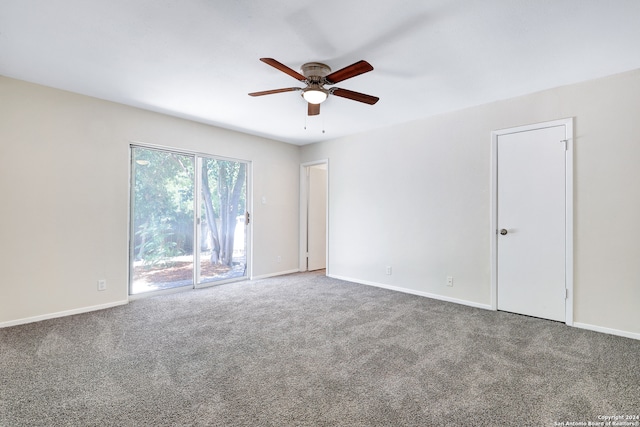 spare room featuring ceiling fan and carpet