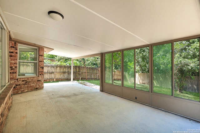 unfurnished sunroom featuring lofted ceiling