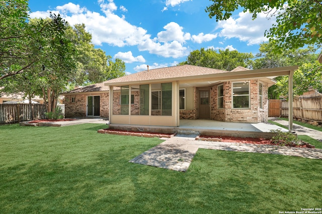 view of front of home with a patio and a front yard