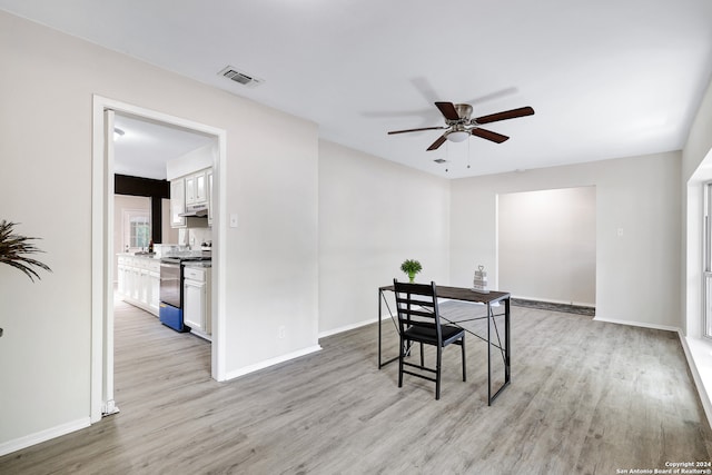 dining space with ceiling fan and light hardwood / wood-style flooring