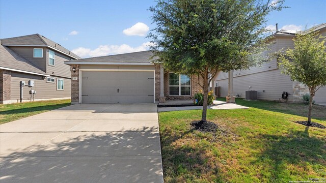 view of front facade featuring a garage, a front lawn, and cooling unit