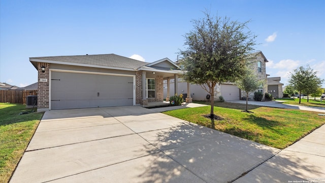 ranch-style house with cooling unit, a garage, and a front lawn