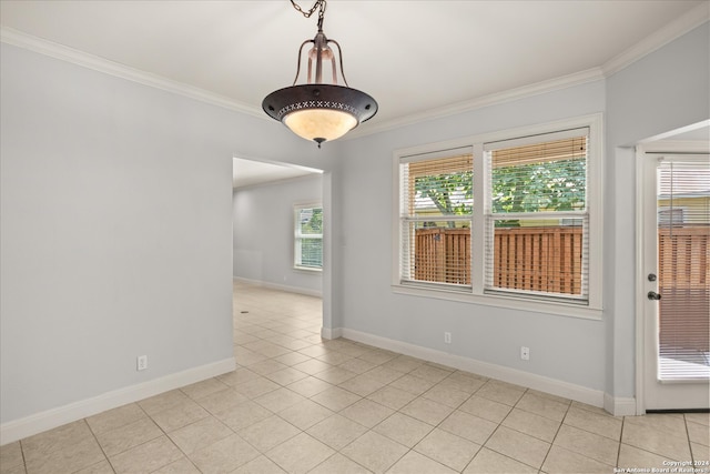 tiled empty room featuring ornamental molding