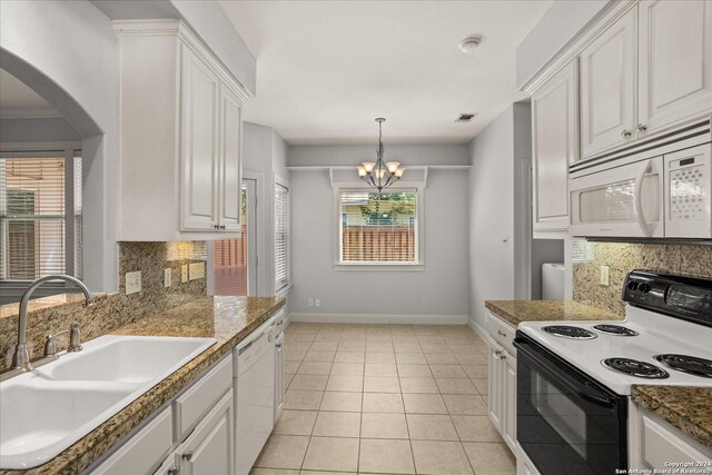 kitchen with tasteful backsplash, sink, white cabinets, light tile patterned floors, and white appliances