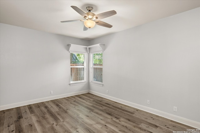 spare room featuring hardwood / wood-style floors and ceiling fan