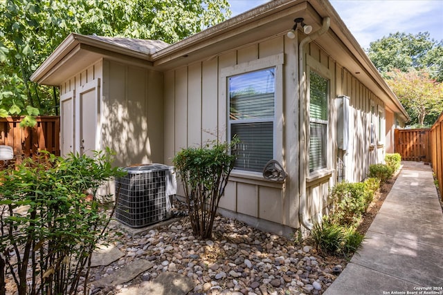 view of side of home with central AC unit