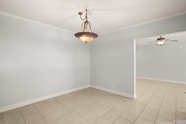 tiled empty room with ceiling fan and ornamental molding