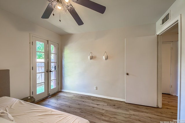 unfurnished bedroom featuring ceiling fan, access to outside, french doors, and light wood-type flooring