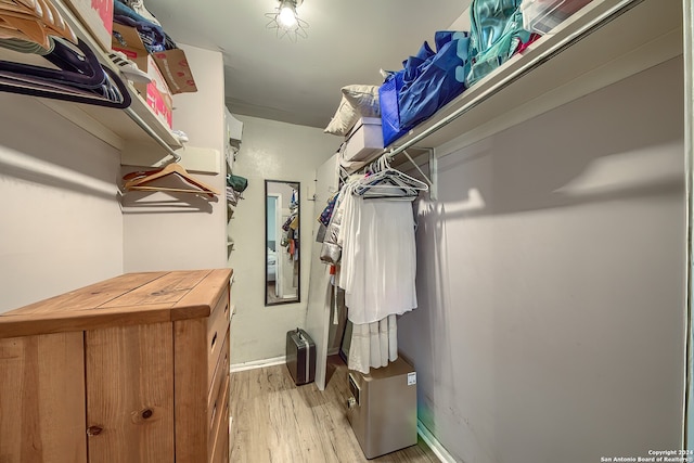 spacious closet with light hardwood / wood-style flooring