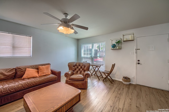 living room featuring ceiling fan and light wood-type flooring