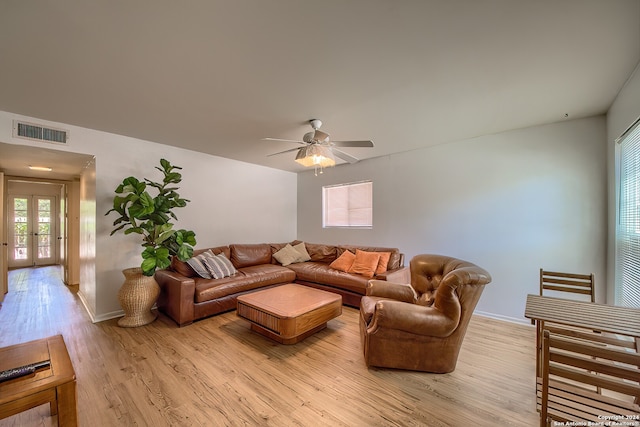 living room featuring a wealth of natural light, french doors, light hardwood / wood-style flooring, and ceiling fan