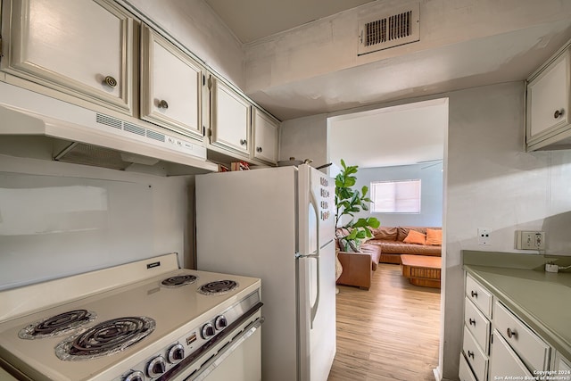 kitchen with light wood-type flooring and range