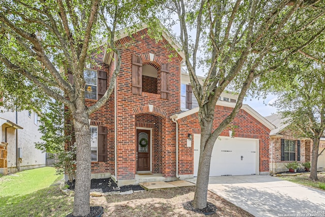 view of front of house featuring a garage, driveway, brick siding, and a front yard