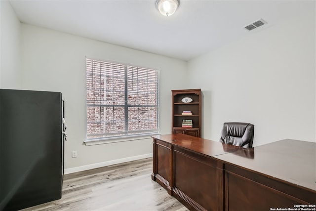 office space featuring light wood-style floors, baseboards, and visible vents