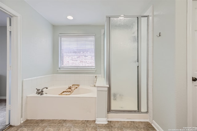 full bath with tile patterned flooring, a shower stall, and a bath