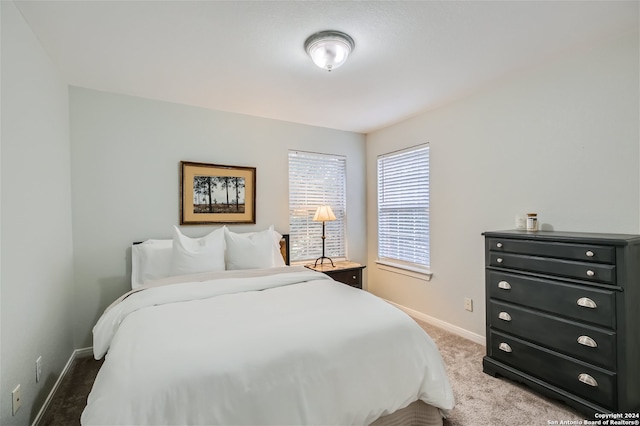 carpeted bedroom with baseboards