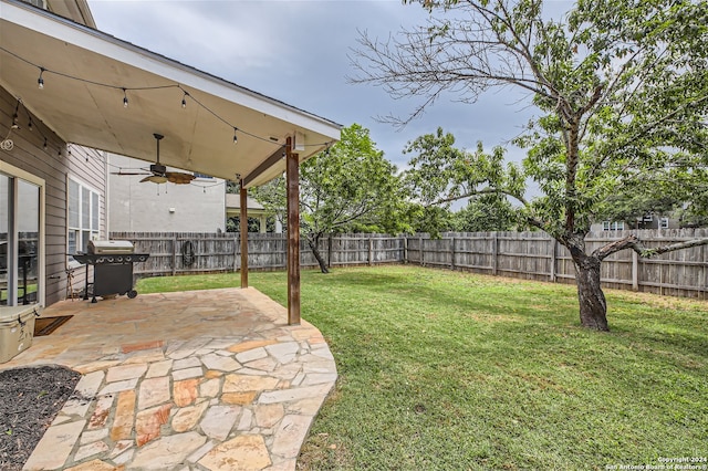 view of yard featuring ceiling fan, a fenced backyard, and a patio