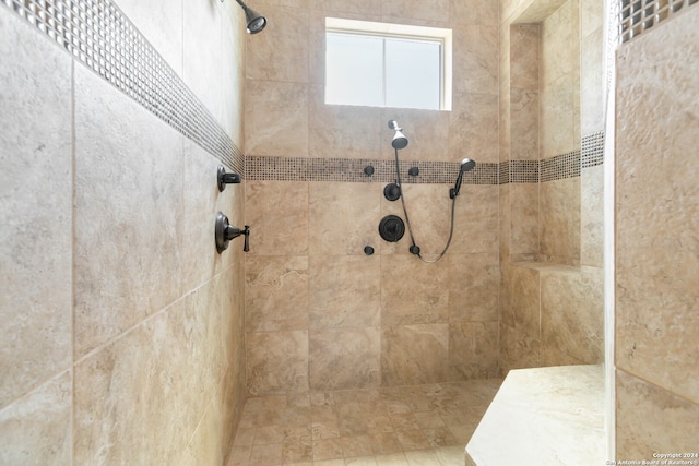 bathroom with tiled shower