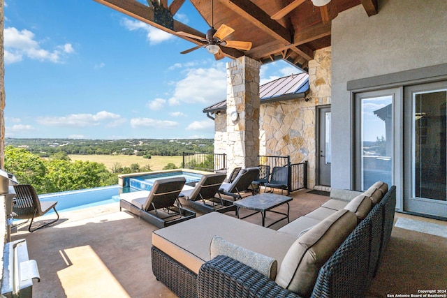 view of patio / terrace with ceiling fan, a pool with hot tub, and an outdoor hangout area