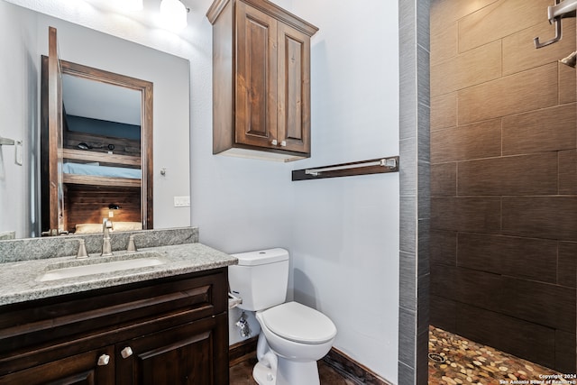 bathroom with a shower, toilet, and vanity