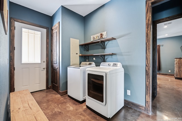 clothes washing area with washer and clothes dryer