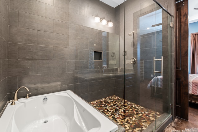 bathroom featuring shower with separate bathtub