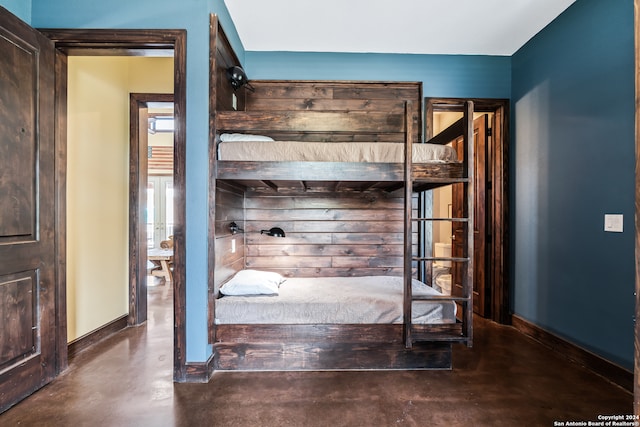 unfurnished bedroom featuring concrete flooring