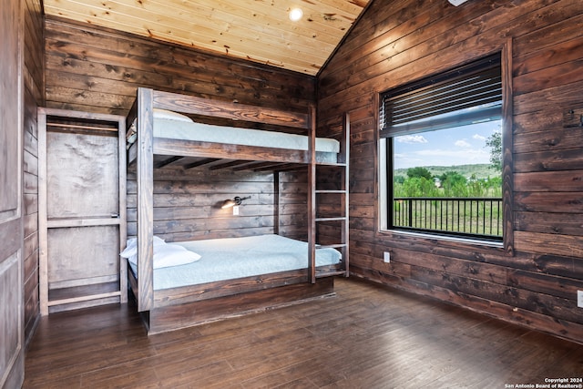 unfurnished bedroom featuring wood walls, lofted ceiling, wood ceiling, and wood-type flooring