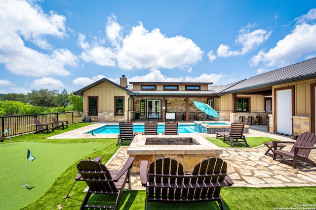 view of swimming pool featuring an outdoor fire pit, an in ground hot tub, and a patio area